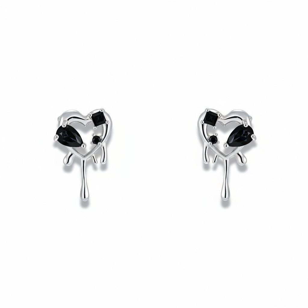 Pair of heart-shaped earrings with black gemstones on a white background