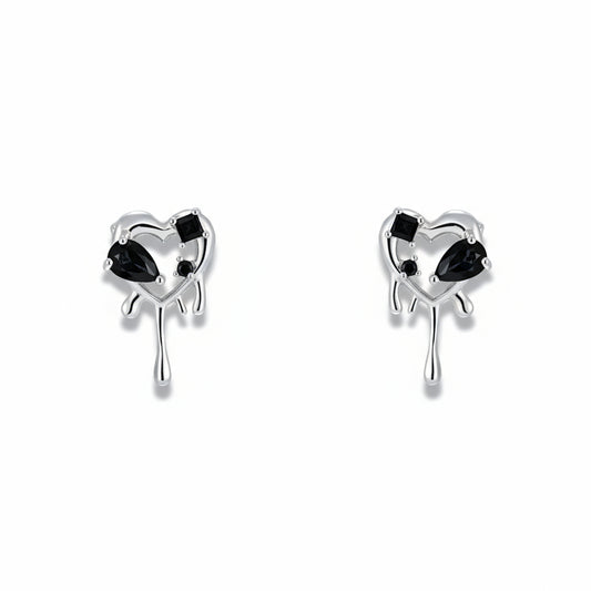 Pair of heart-shaped earrings with black gemstones on a white background