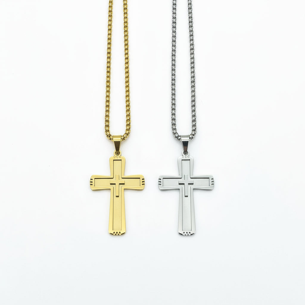 Gold and silver cross pendants on chains against a dark wooden background
