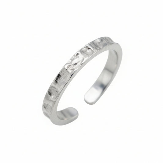 Silver toe ring with small stones on a white background