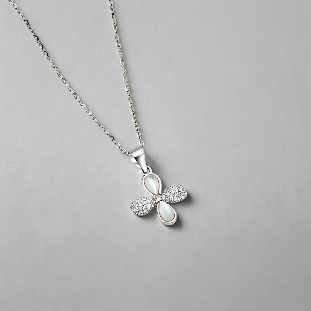 Silver necklace with a bow-shaped pendant on a white background