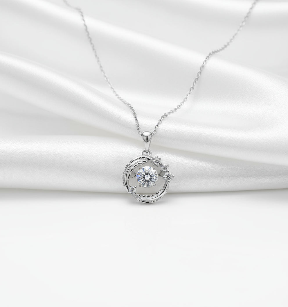 Silver necklace with a round pendant on a black background