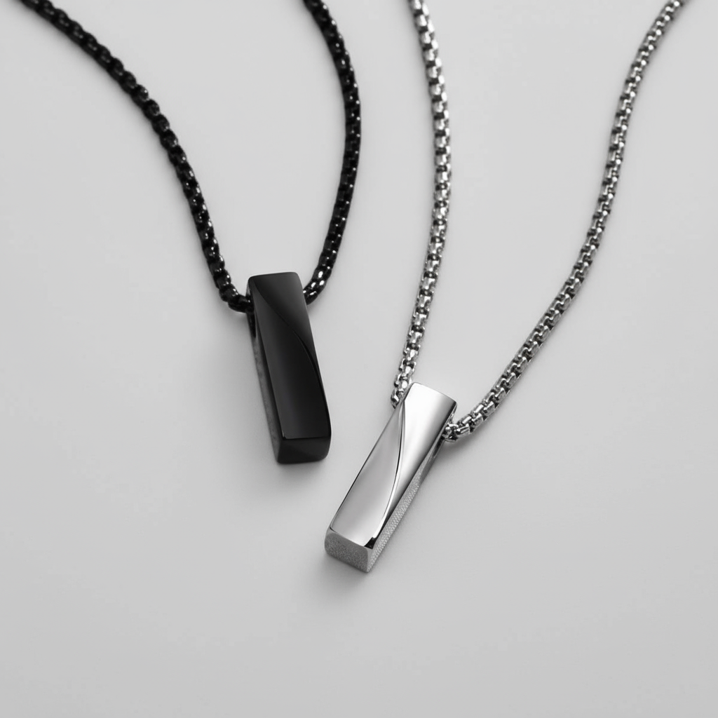Two necklaces with black and silver pendants on a white background