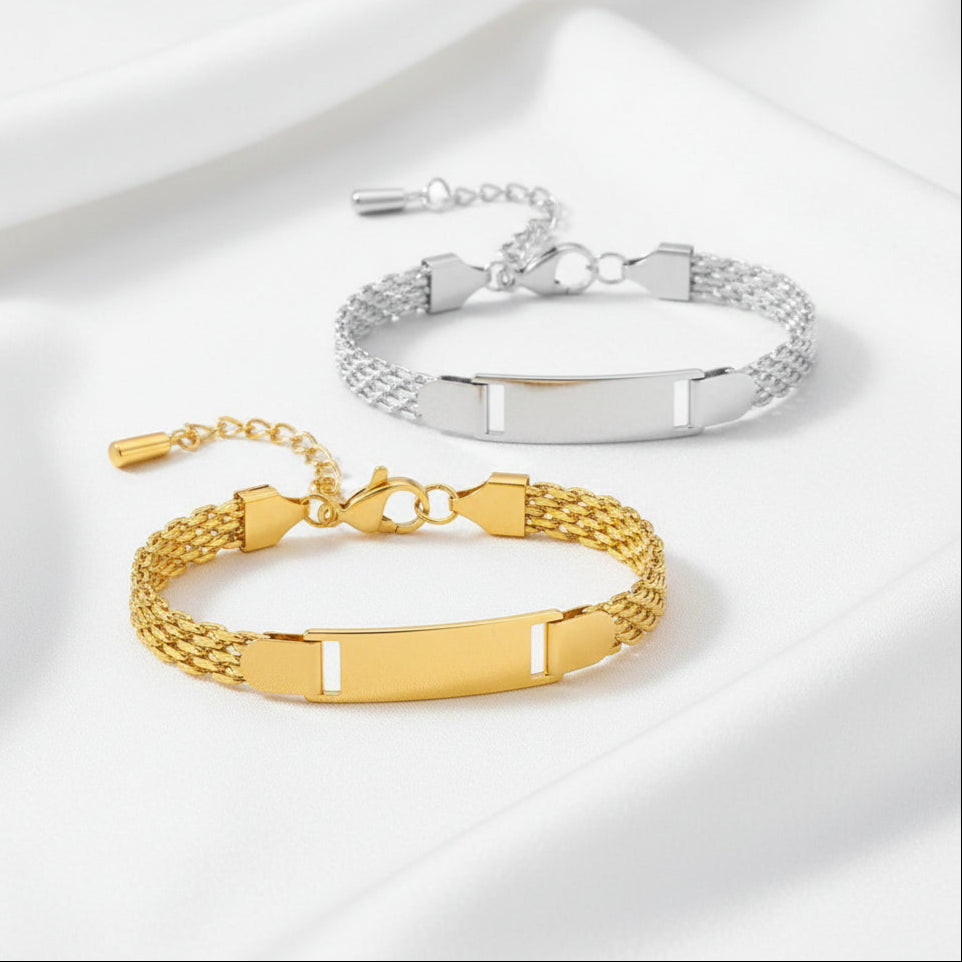Two gold and silver bracelets with engraved bands on a white background