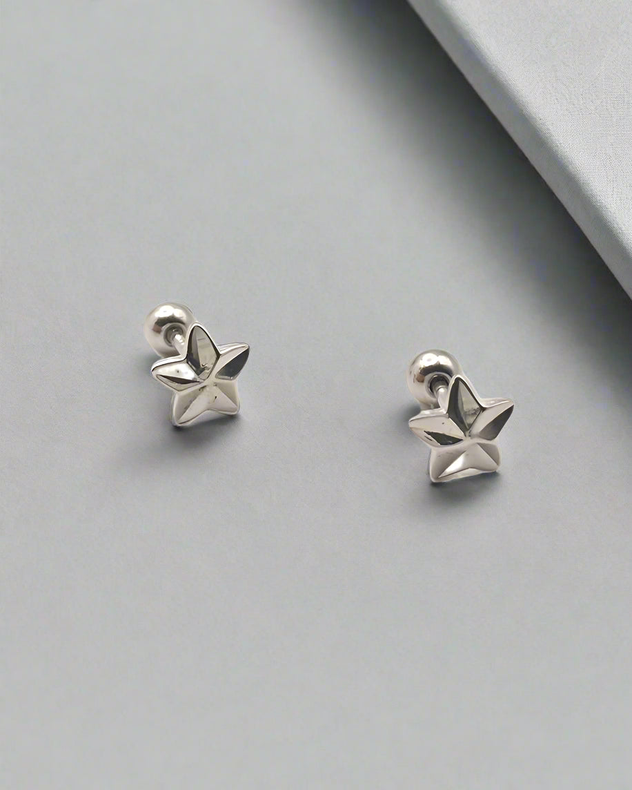 Pair of silver star-shaped earrings on a white background