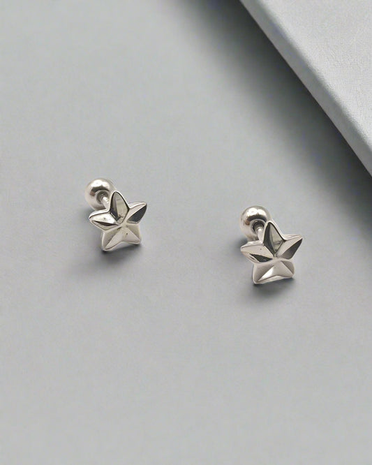 Pair of silver star-shaped earrings on a white background
