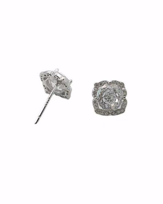 Silver rose-shaped earrings on a white background