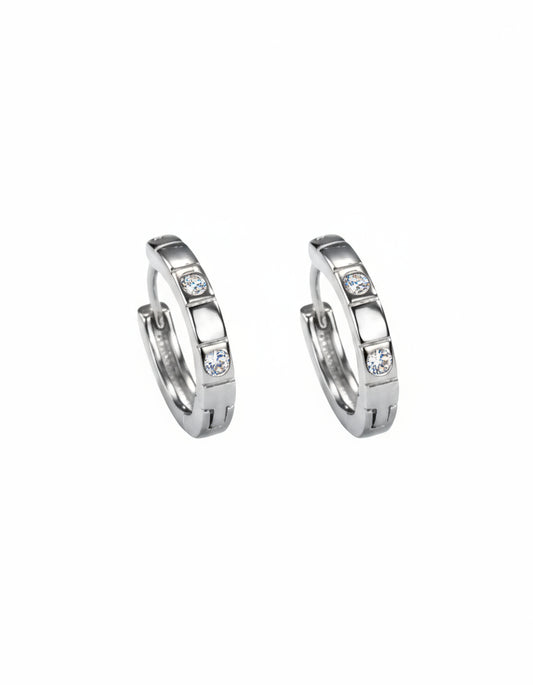 Pair of silver hoop earrings with embedded stones on a white background