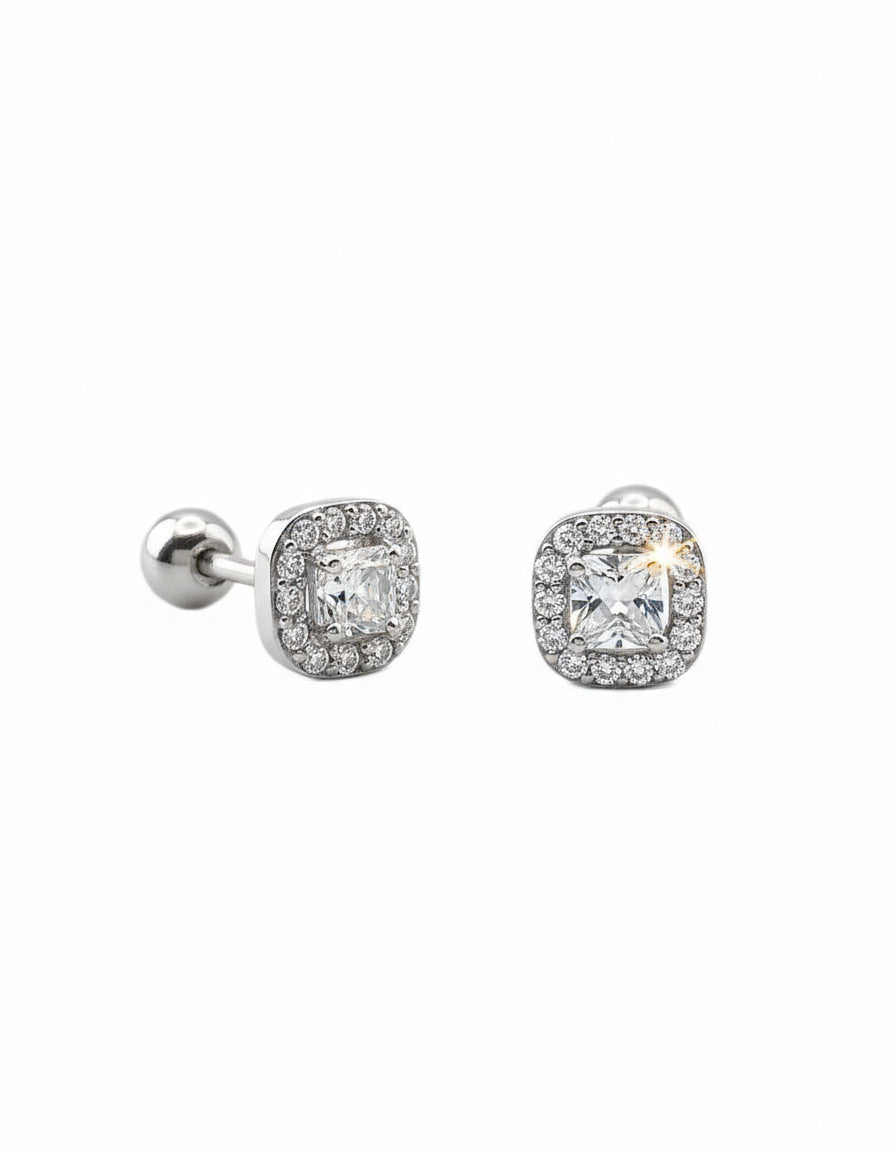 Pair of silver earrings with cubic zirconia on a white background