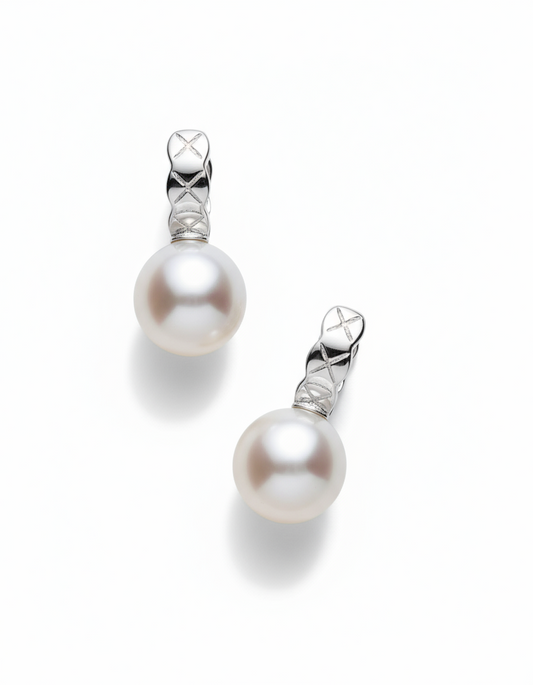 Pair of pearl earrings with silver hooks on a white background