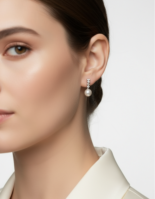 Pearl earrings with silver clasps on a white background