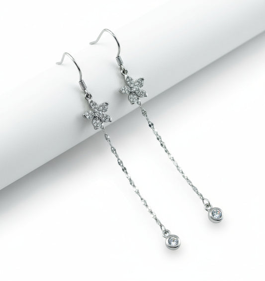 Silver earrings with floral designs on a white background