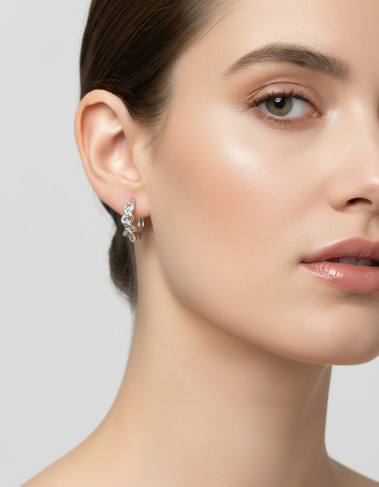 Pair of silver hoop earrings on a white background