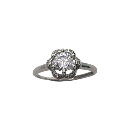 Diamond ring with a halo setting on a white background