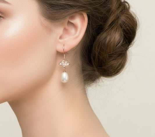 Pearl earrings with rose gold hooks on a white background