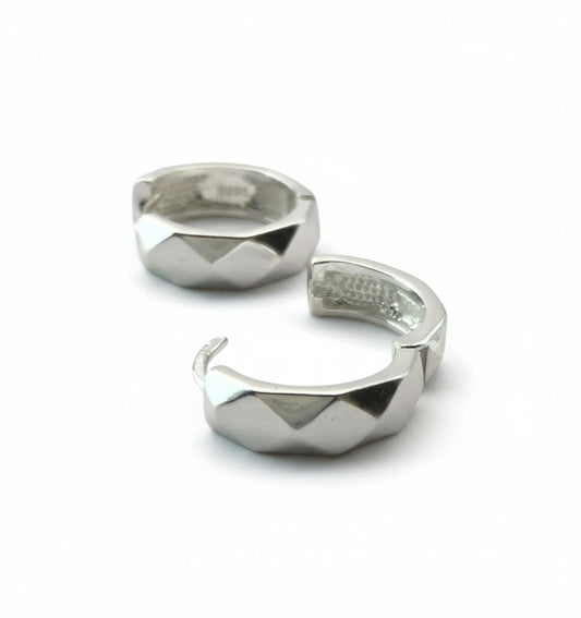 Two silver rings with geometric designs on a white background