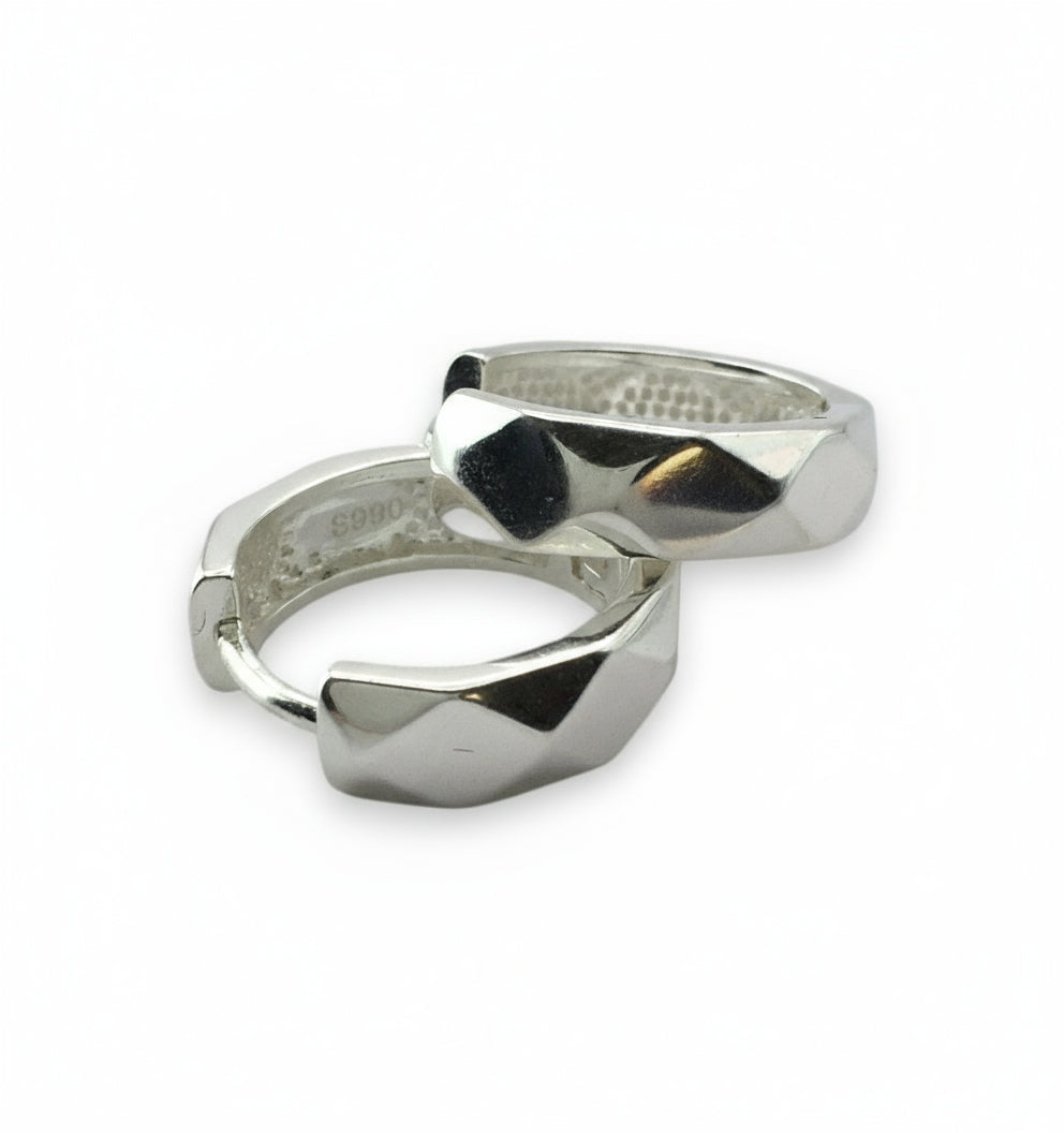 Two silver rings with geometric designs on a white background