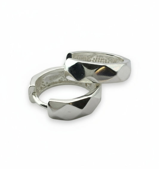 Two silver rings with geometric designs on a white background