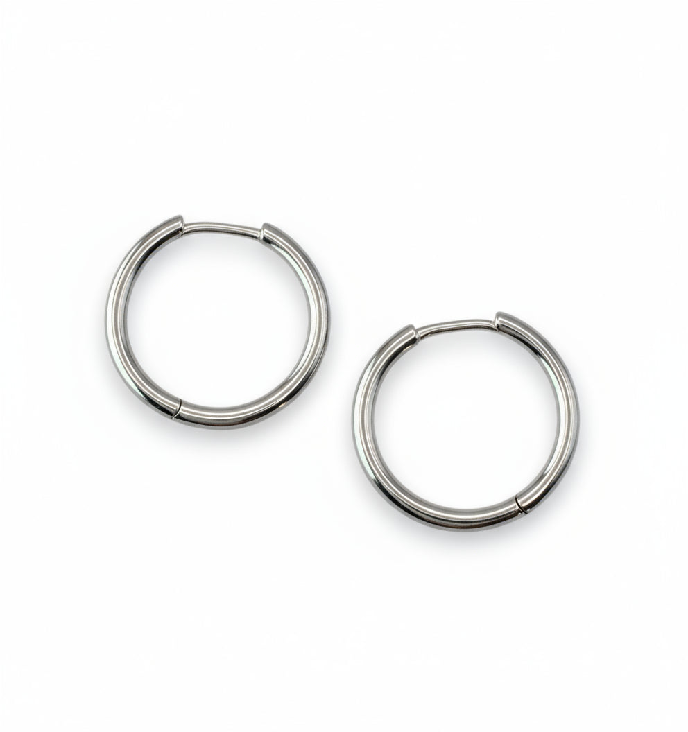 Pair of silver hoop earrings on a white background