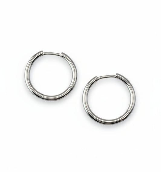 Pair of silver hoop earrings on a white background