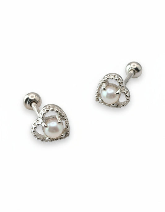Heart-shaped earrings with white stones on a white background