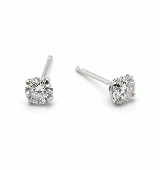 Pair of silver stud earrings with clear gemstones on a white background