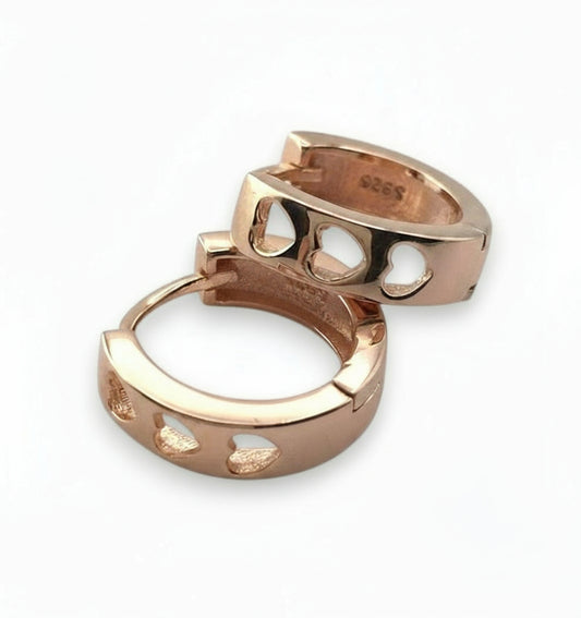 Rose gold ring with cut-out design on a white background