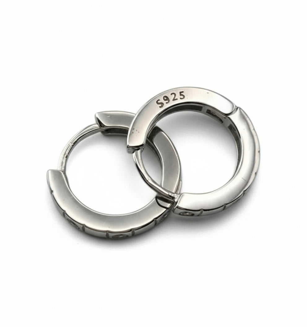 Pair of silver hoop earrings with 'S925' stamp on a white background