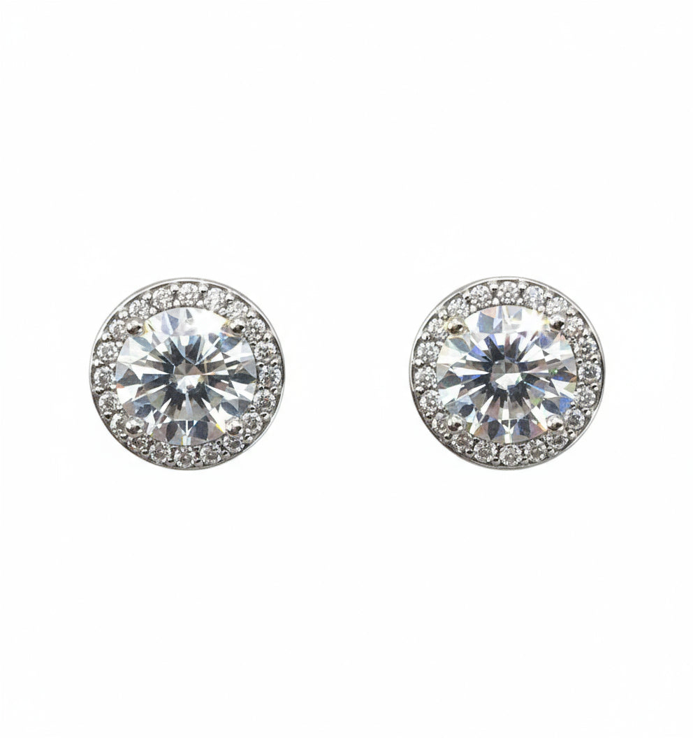 Pair of silver stud earrings with clear gemstones on a white background