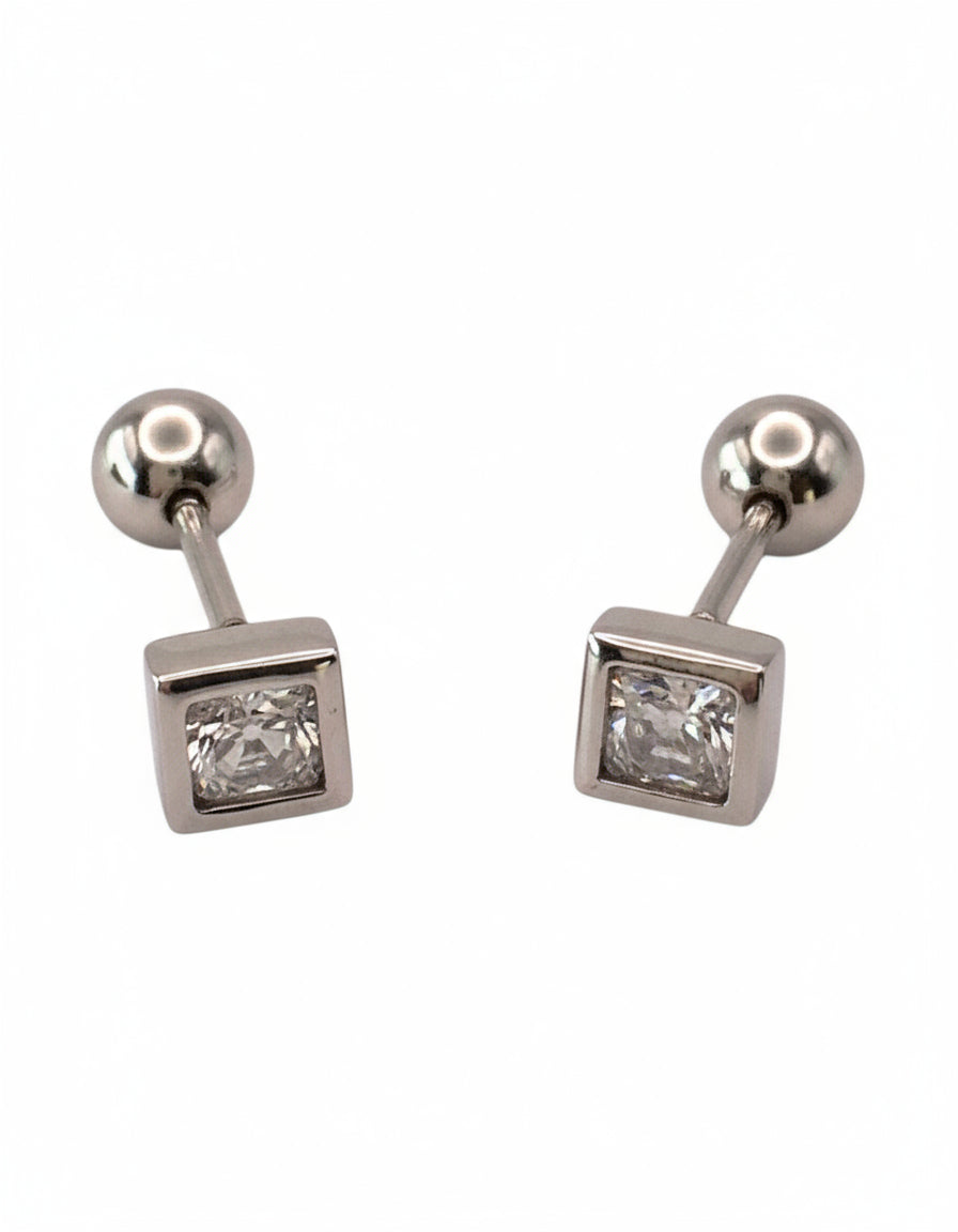 Pair of silver earrings with square gemstones on a white background