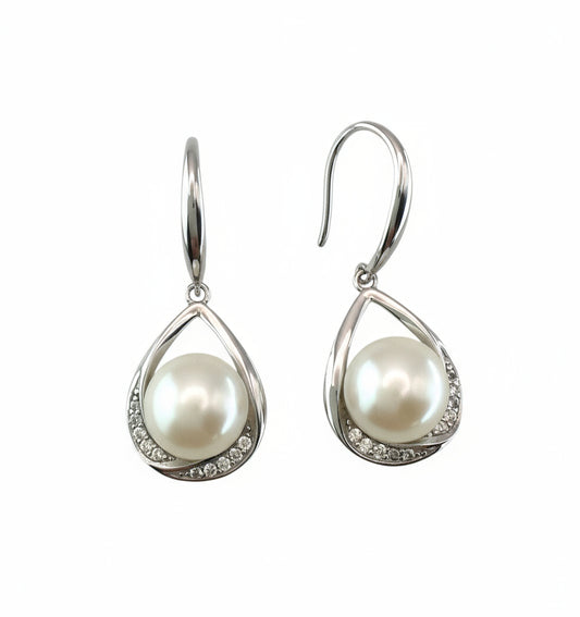 Pearl earrings with silver teardrop designs on a white background