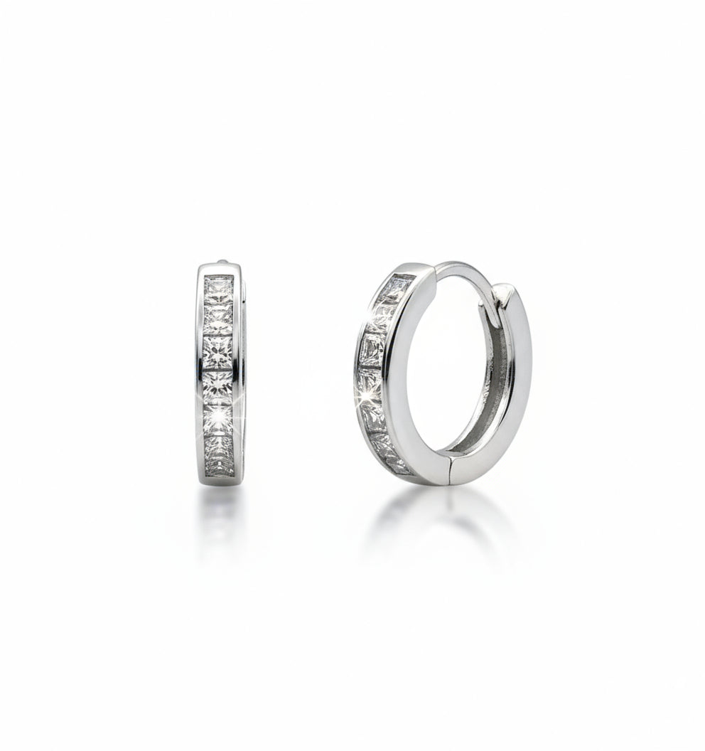 Pair of silver hoop earrings with embedded stones on a white background