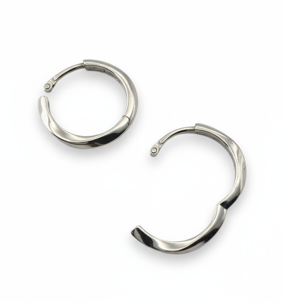 Pair of silver hoop earrings on a white background
