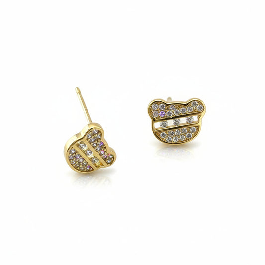 Gold earrings with lip design on a white background