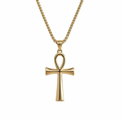 Gold cross pendant necklace on a white background