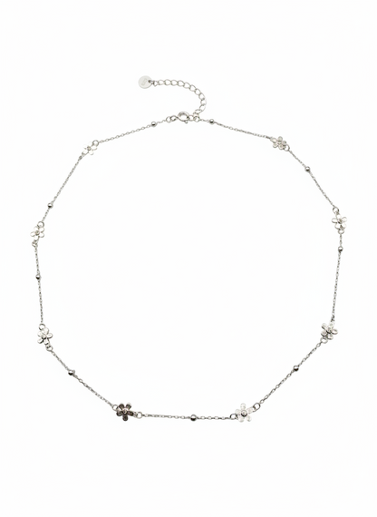 Silver necklace with small floral pendants on a white background