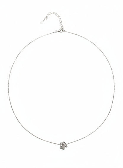 Silver necklace with a small pendant on a white background