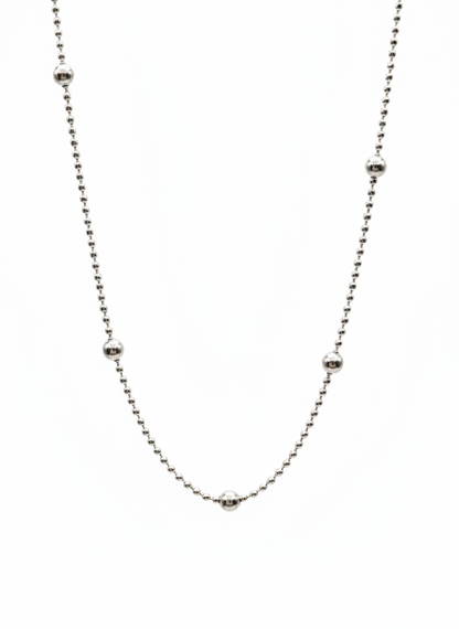 Thin silver chain necklace on a white background