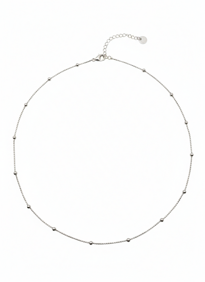 Silver necklace with small beads on a white background