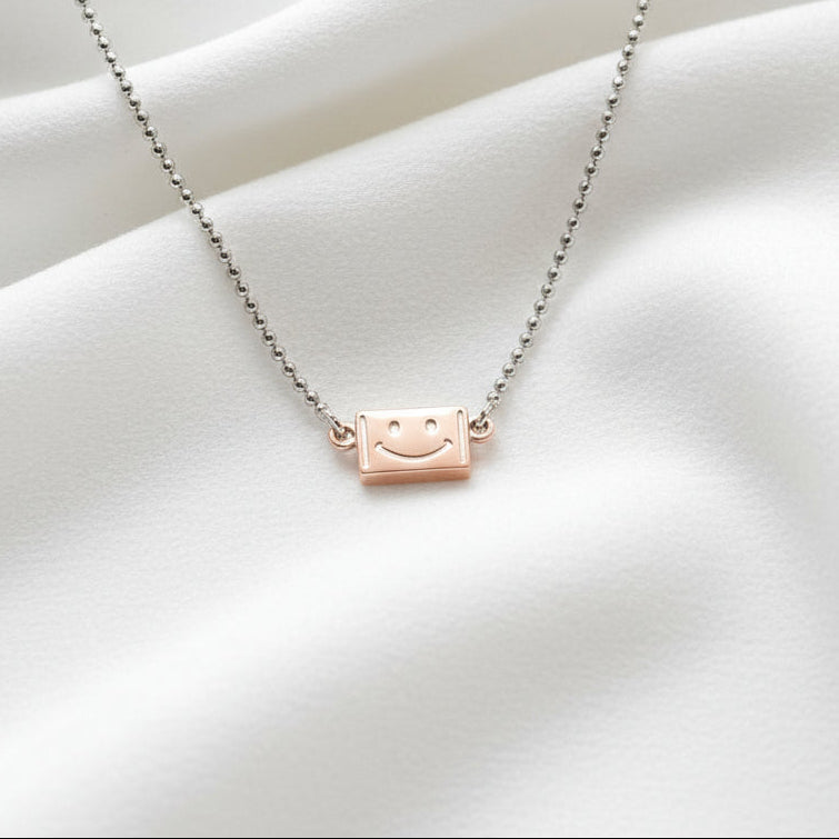 Necklace with a small brown leather tag pendant on a white background