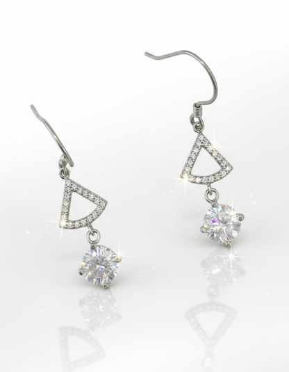 Pair of silver earrings with triangular designs and clear cubic zirconia on a white background