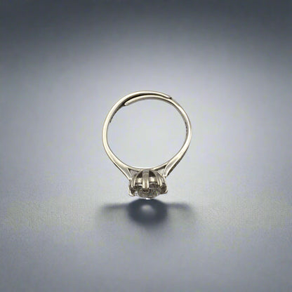 Silver ring with a small stone on a white background