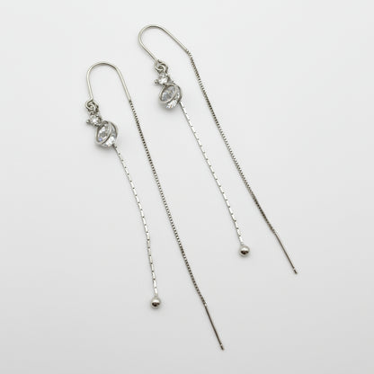 Pair of silver threader earrings on a white background