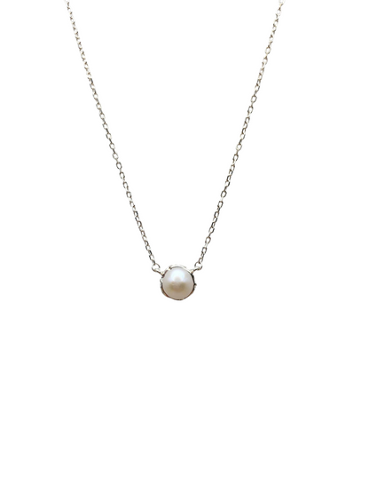 Pearl necklace on a thin chain against a white background