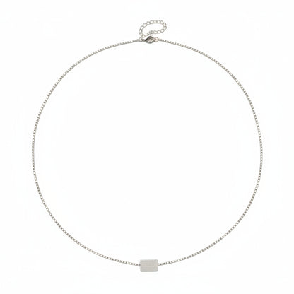 Silver necklace with a square pendant on a white background