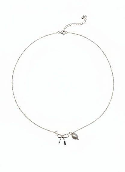 Necklace with bow and leaf pendant on a white background