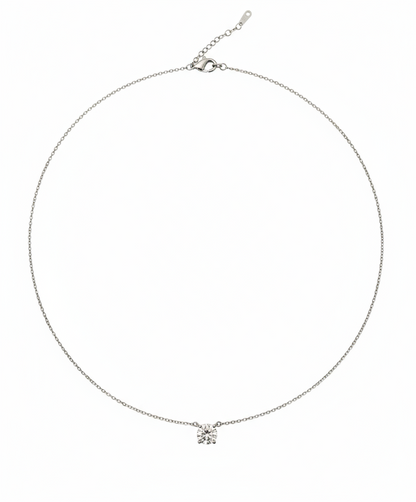 Silver necklace with a small pendant on a white background