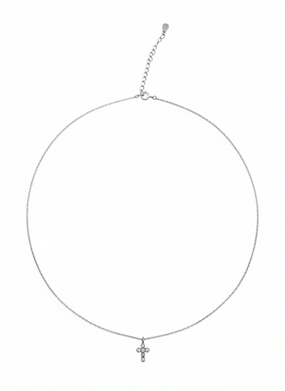 Silver necklace with a small cross pendant on a white background
