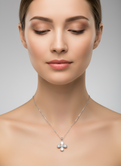 Silver cross pendant necklace on a white background