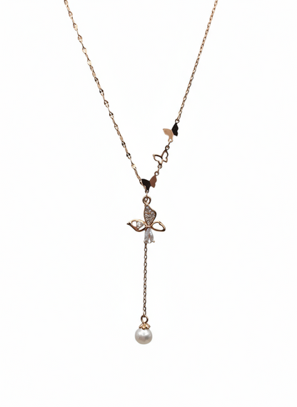Delicate necklace with a small pendant and pearl drop on a white background